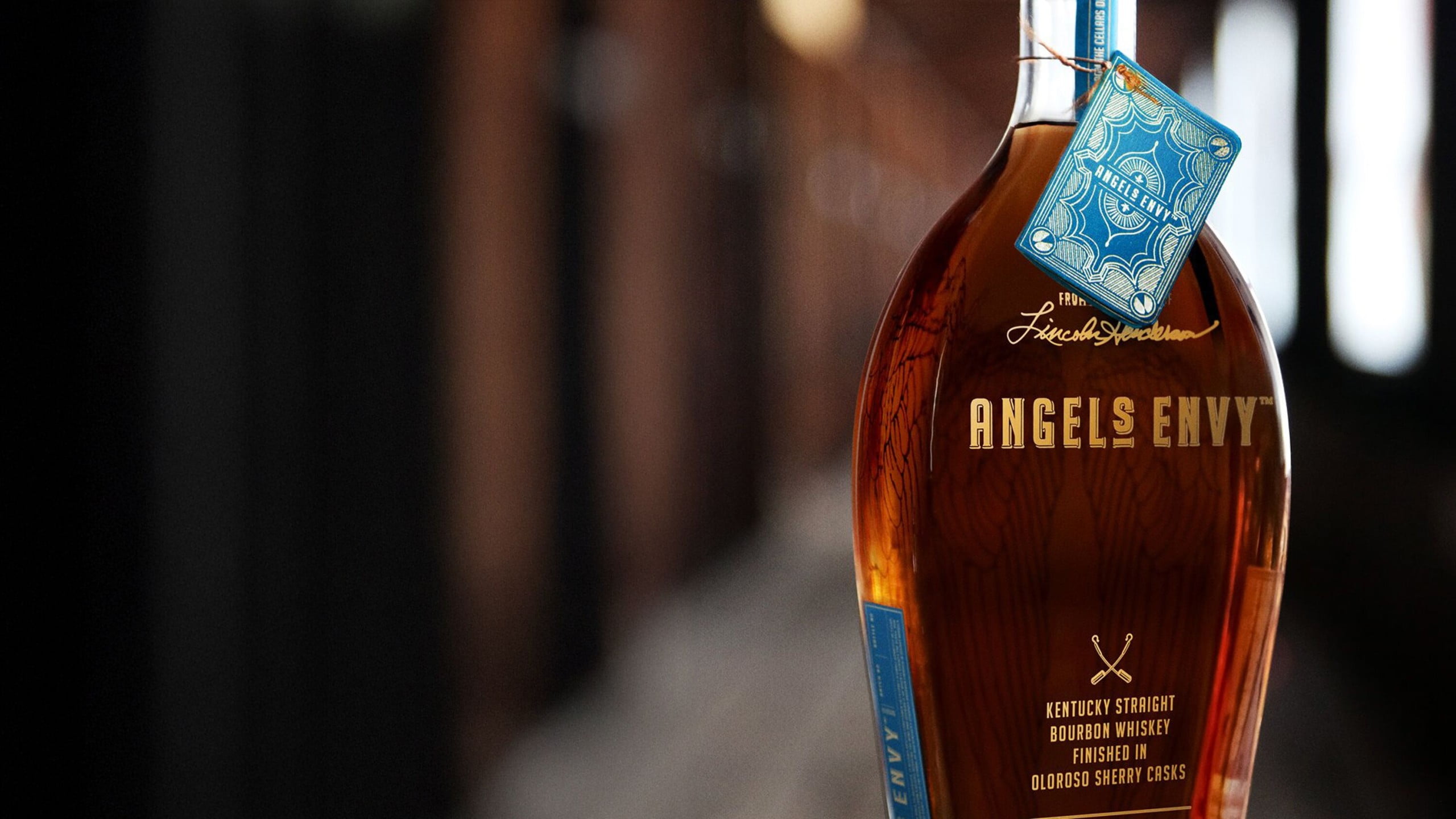 A bottle of the Angel’s Envy Cellar Collection Vol. 1 Bourbon featuring detailed bottle tag in light blue at the Angel’s Envy distillery in Louisville, Kentucky.