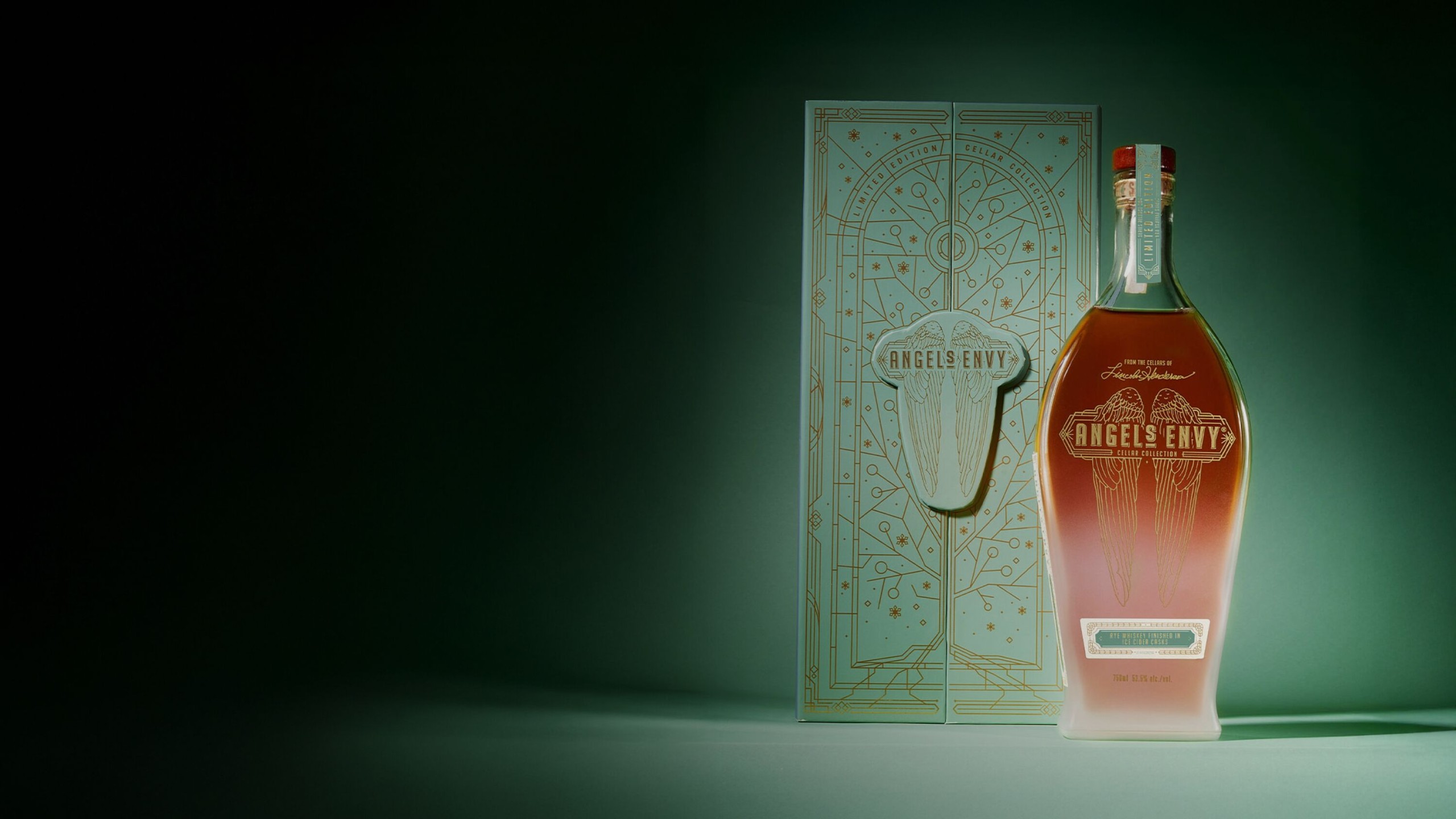 The Angel’s Envy Cellar Collection Vol. 4 bottle with a frosted appearance and its intricately-detailed light green presentation box in front of a tonal background.