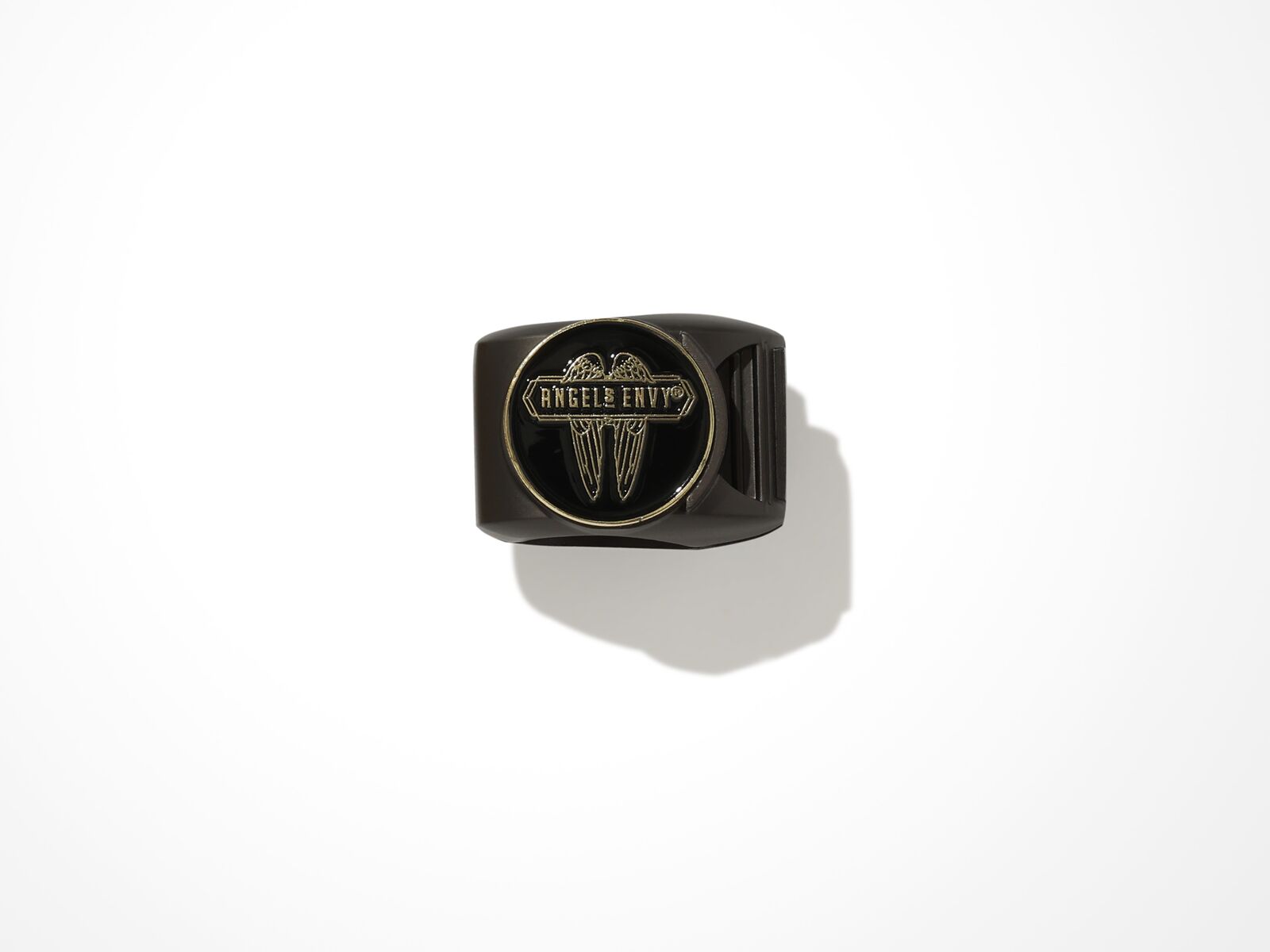 The black Angel’s Envy Magnetic Cigar Clip & Ball Marker with bronze outlined detailing.