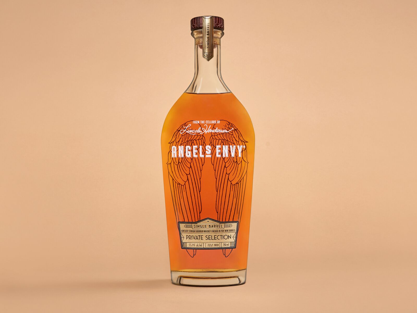 A bottle of the Angel’s Envy Single Barrel Bourbon Finished in Port Wine Barrels staged on a soft orange background.