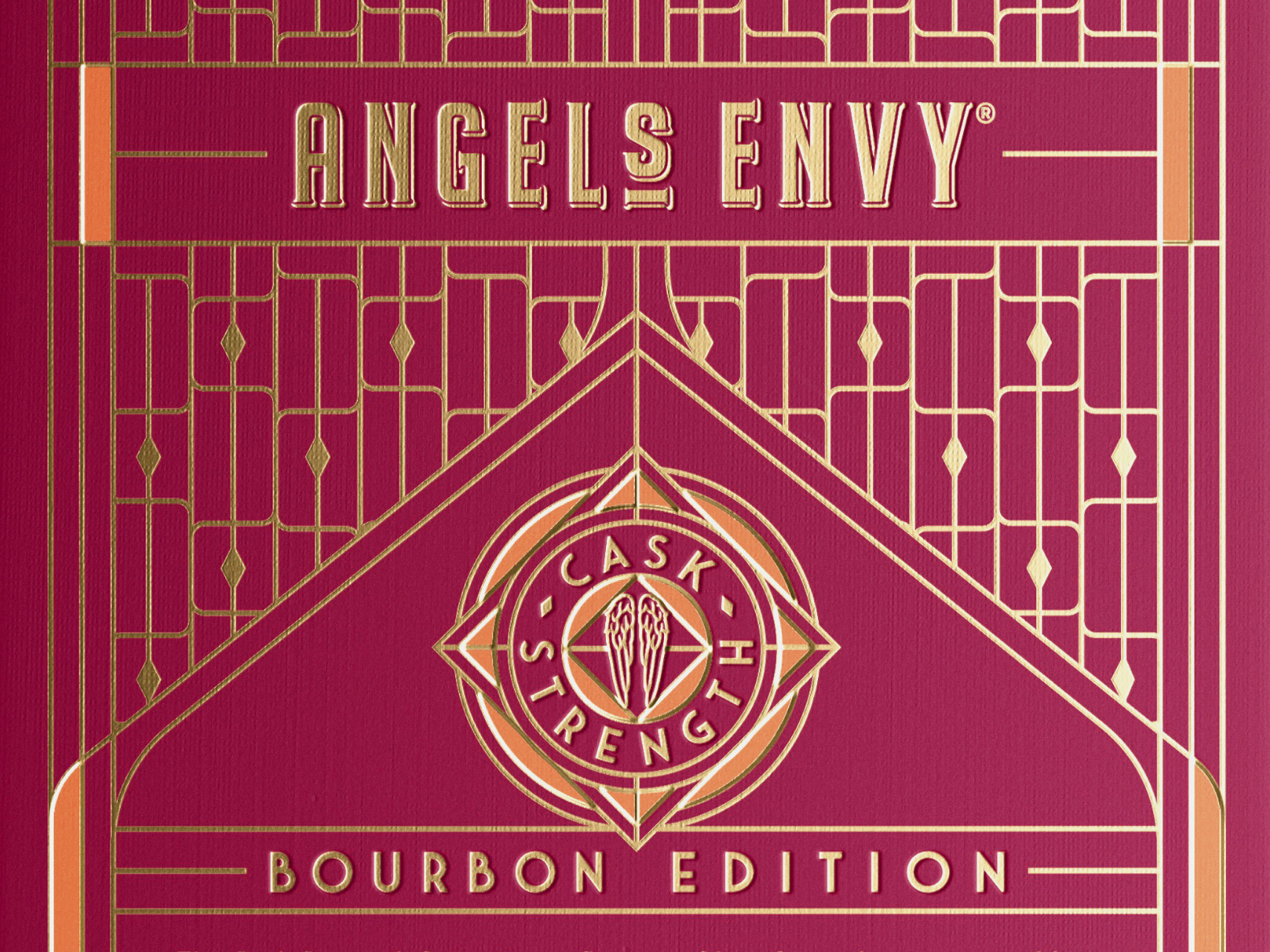 A close-up of the Angel’s Envy 2026 Cask Strength Bourbon limited-edition presentation box in ruby and gold.