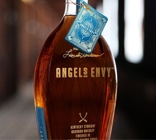 A bottle of the Angel’s Envy Cellar Collection Vol. 1 Bourbon featuring detailed bottle tag in light blue.