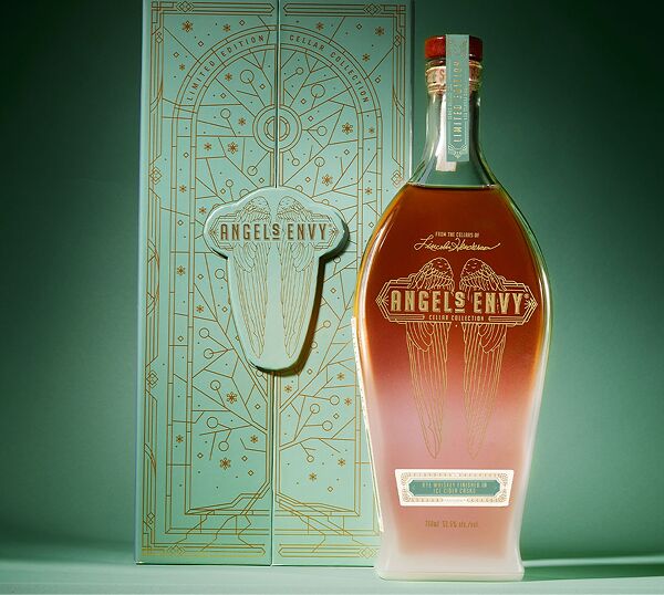 The Angel’s Envy Cellar Collection Vol. 4 bottle with a frosted appearance and its intricately-detailed light green presentation box in front of a tonal background.