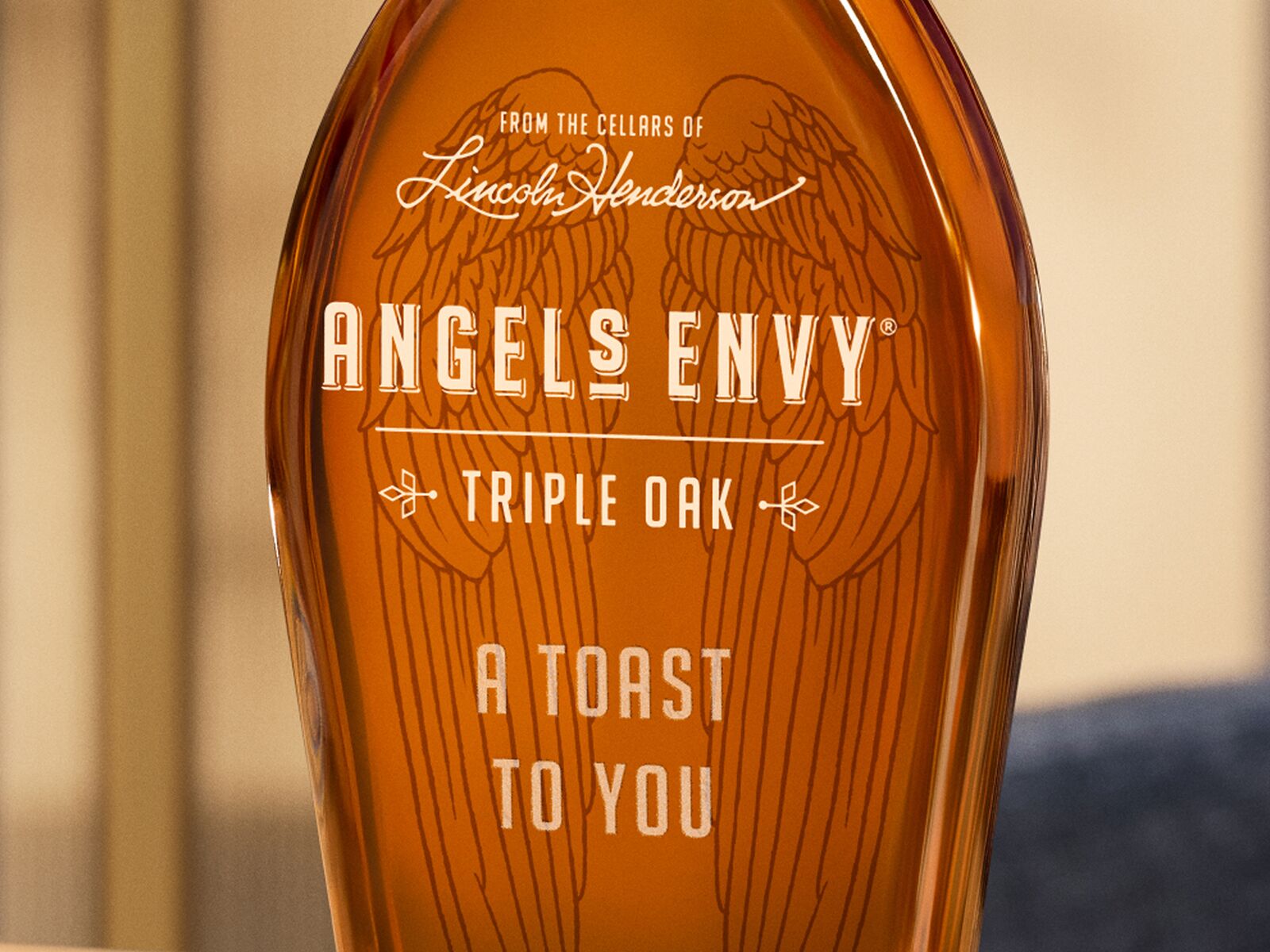 The phrase “A toast to you” beautifully etched into a bottle of Angel’s Envy Triple Oak Bourbon.