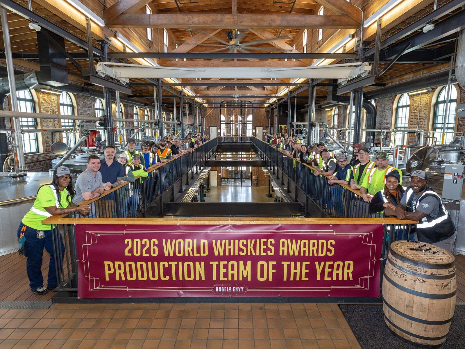 The Angel’s Envy production team gathered inside the distillery behind a banner reading ‘2026 World Whiskies Awards Production Team of the Year’.